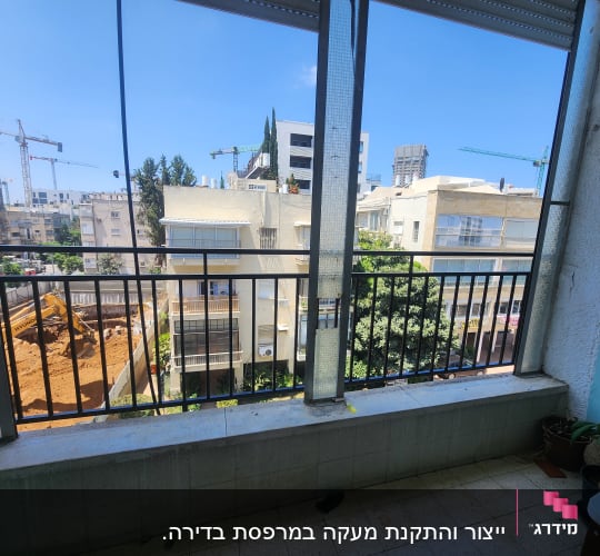 מרפסת עם מסגרת מתכת ונוף עירוני